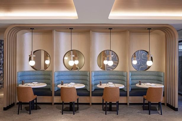 The restaurant's dining room design takes cues from Streamline Moderne style with contemporary sensibilities. Porthole-like openings at the banquette recall Miami’s cruise industry while maintaining visual connection within the space. (credit: Noah Webb)