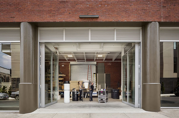 The workshop is enclosed with 13-foot-high operable glass doors that open onto the street to allow full-size mockups and large materials to be moved in and out of the building easily. | © Michael Moran/OTTO