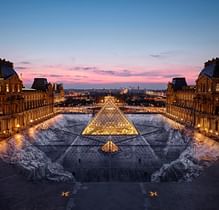 For its 30th birthday, Artist JR creates a large-scale optical illusion at the Louvre Pyramid