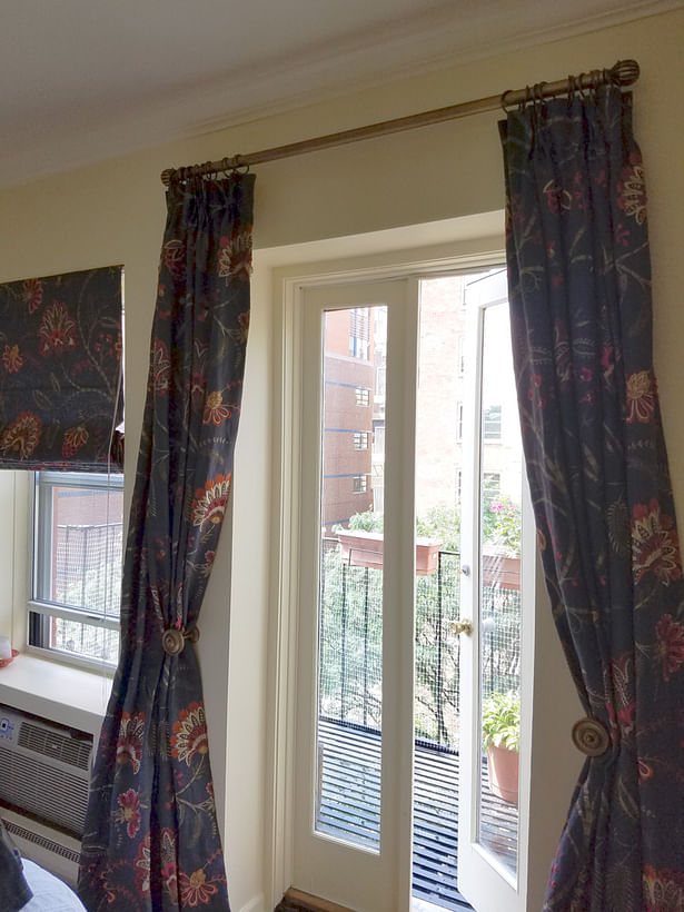 Master bedroom's new window treatments at French doors to a sunny balcony.