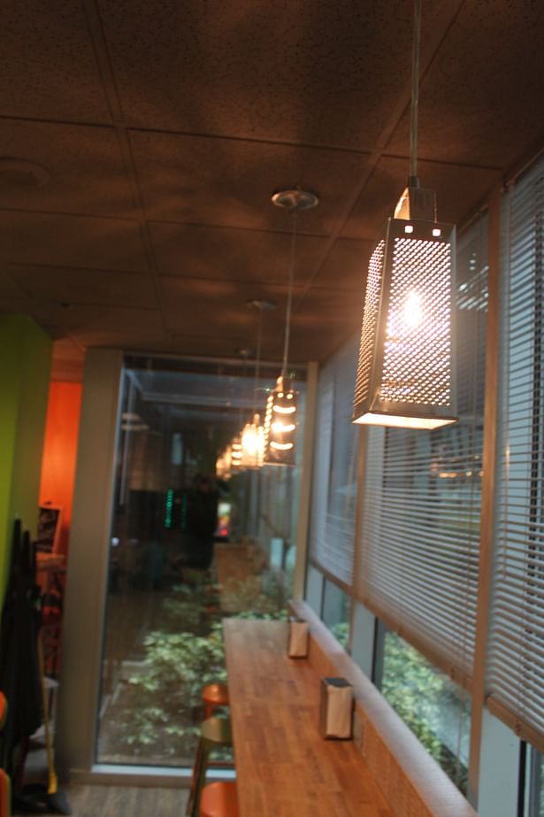I designed these cheese grater pendant lights for the bar seating. 