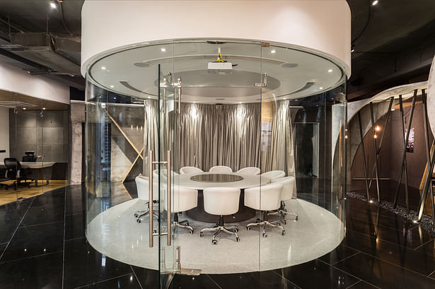The Circular glass conference room dominates the office space, with the rest of the spaces revolving around it.