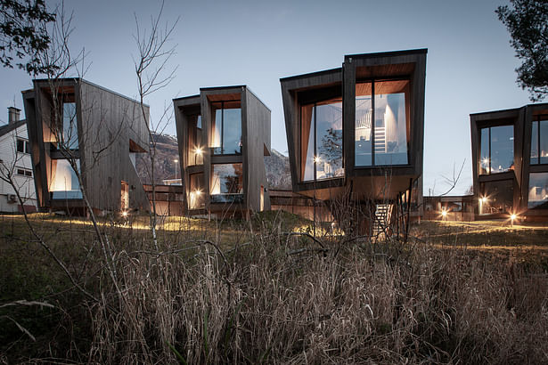 Small cabin units with protected wetland habitat in the foreground. Photo: Sam Hughes.