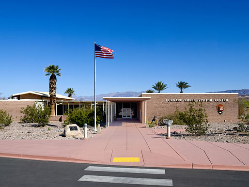 Furnace Creek - Entrance Façade after rehabilitation. Walls were cleaned and repaired and the deteriorated site paving was replaced with improvements for passenger loading and accessibility. This principal façade largely retains its historic appearance, complemented by the historic gravel roof surface which was recreated at sloped Auditorium roof to left. Credit: David Wakely