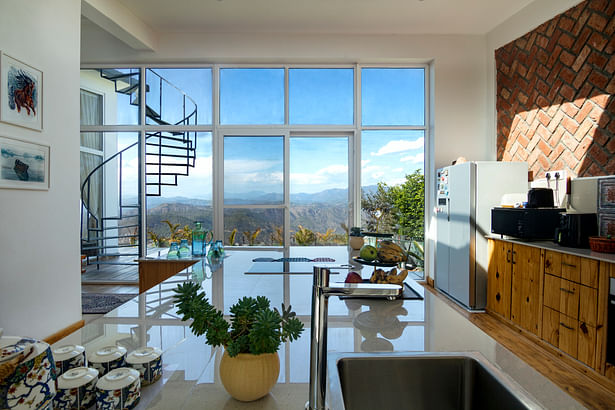 Kitchen island overlooking to the northern mountain ranges. Notice the light on the right falling from the skylight.