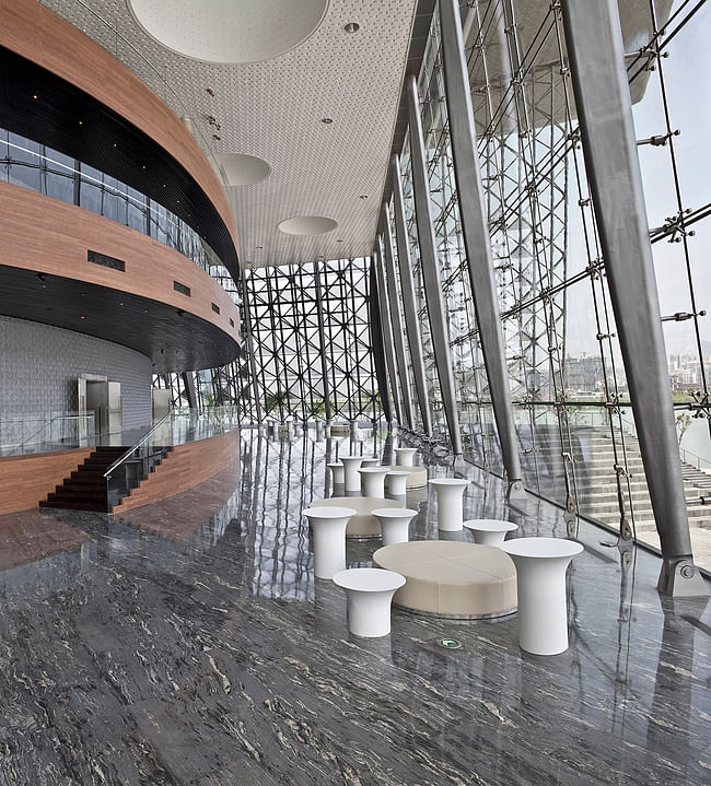 The lake side lobby of the main auditorium. This elevated space is providing great views over the Wuli Lake. The auditorium is accessed via bamboo balconies. The curved auditorium wall is covered with a custom designed glass brick wall. (Photo: Kari Palsila)