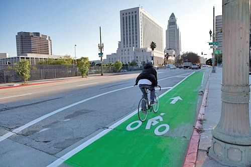 Green bikes lanes in LA help create space for bicyclists on the city's notoriously dangerous roads. Via: CurbedLA
