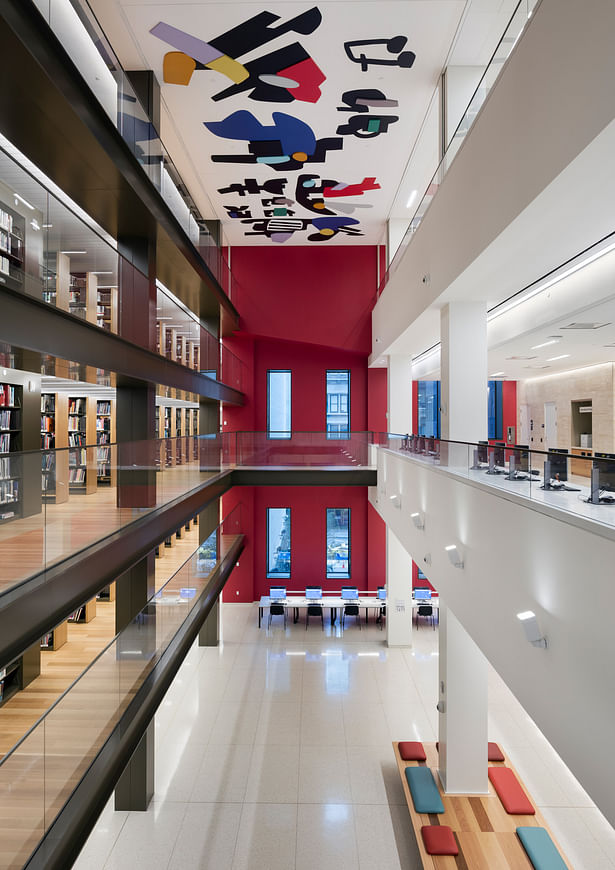The Long Room’s atrium wall at the southern end is deep red, and perforated with new windows to bring light from a pocket park to the south. Its distinctive look assists wayfinding. Image copyright by John Bartelstone