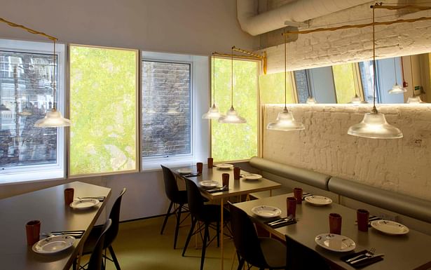 Restaurant interior with backlit art walls with depictions of the Dehesa landscape by Binom