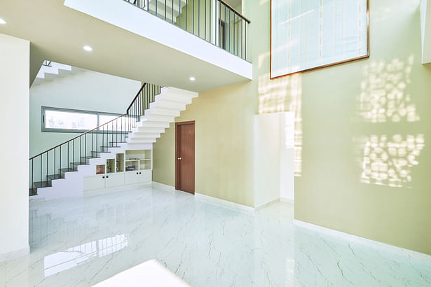 Double height Dining room with roof skylight and staircase core. 