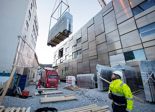 Facade elements being hoisted into place during construction of the Faculty of Fine Art, Music and Design ('KMD'). Image courtesy of Statsbygg