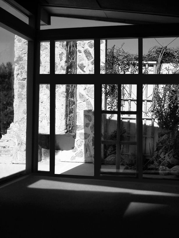 The view from the studio faces out to the patio. The studio opens up out to the fireplace and landscaping.