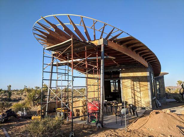 Detail showing strawbale walls and elliptical roof framing.