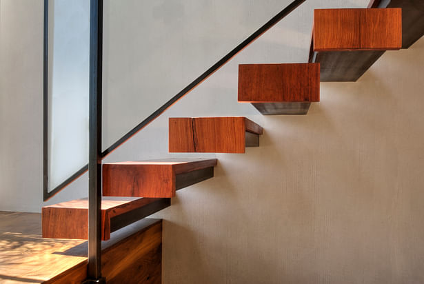 The floating staircase is made of 100-year-old teak, glass and blackened steel. The wood, from Berber World Imports in Culver City, was reclaimed and milled to fit the structural steel supports that are anchored in the wall.