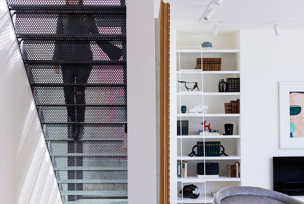 To maintain the addition's sense of transparency, local artisans fabricated a perforated metal staircase that leads directly to the master bedroom suite on the second floor.
