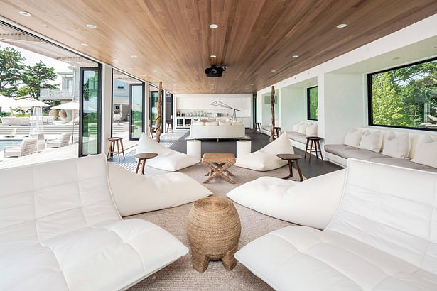 Open Entertaining Space on Main Level of Guest Wing with Wall of Folding Glass Doors to Pool Deck