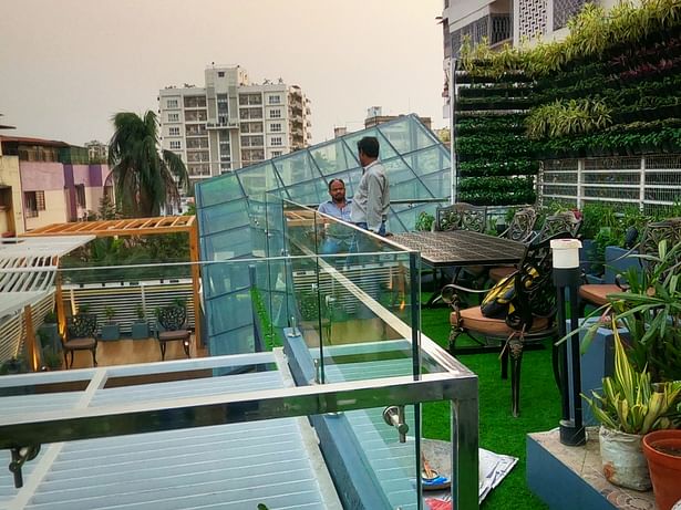 The second level of the terrace garden flaunts a lush green dining space with vertical gardening on the western side to block the harsh rays of the sun and glass railing on the south eastern side to welcome the sea breeze during the evenings.