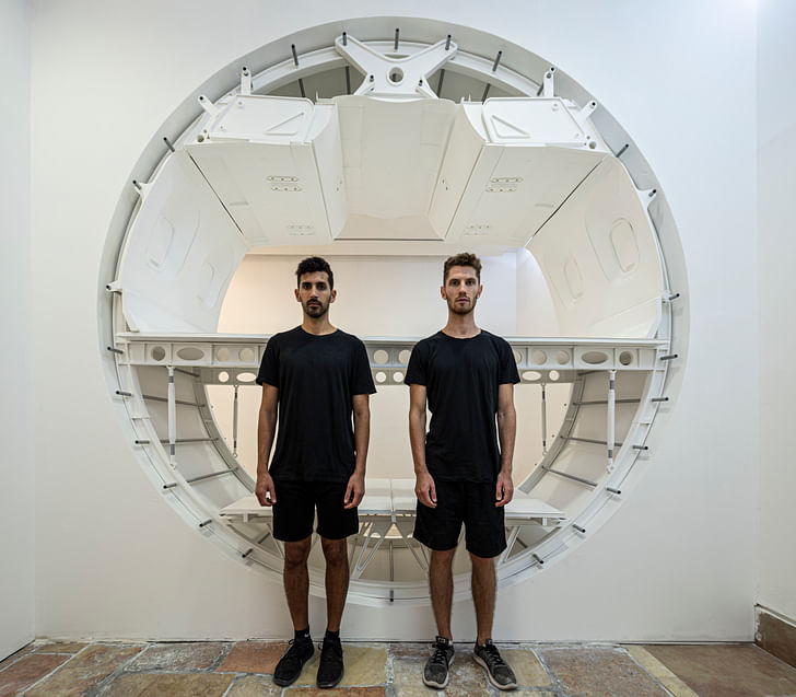 Charles Weinberg and Shai Ben-Ami standing in front of their 1:1 scale model. Image © Michael Shvadron via Charles Weinberg and Shai Ben-Ami