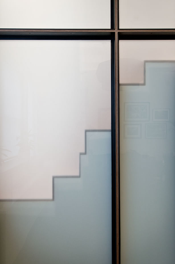 Translucent Wall Panels Allow Daylight and Project a Profile of the Quirky Alternating Tread Stair