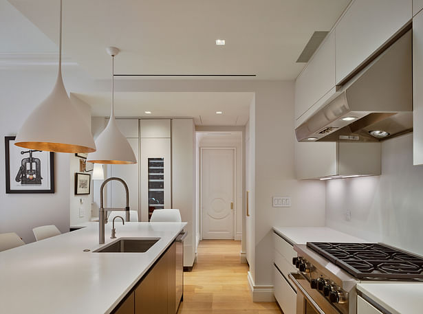 The kitchen features very clean and minimal cabinetry design fabricated by Cesar Kitchens. 