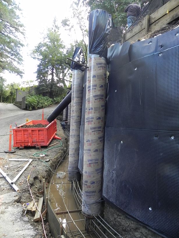 Retaining wall with waterproofing and pilasters almost finished. 