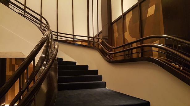 Continuous curved wooden handrail in a restaurant in New York, USA 