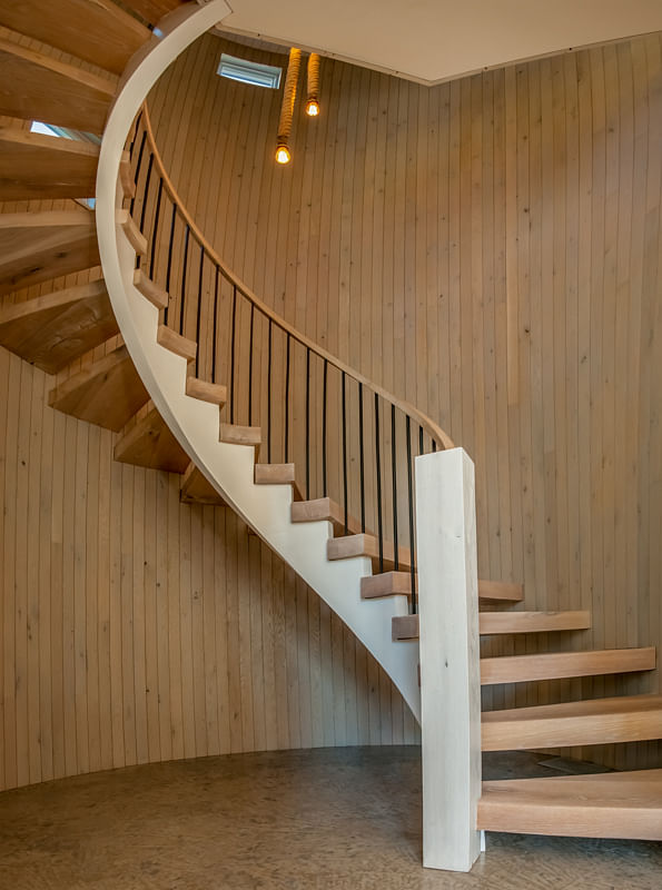 This staircase was custom designed and built off-site. The silo in which it sits is a mere inch wider than the staircase. 