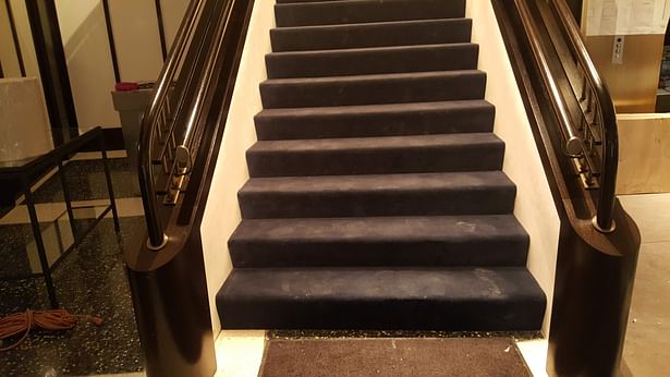 Continuous curved wooden handrail in a restaurant in New York, USA 