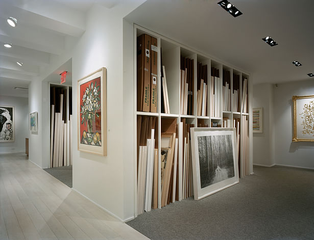 The artwork is available for clients to view in a library setting. This is made possible by a system of built-in millwork where prints can be easily filed and accessed much as books are in a library.