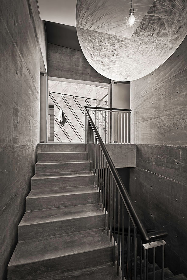 Formed concrete is prevalent throughout the home, the simplicity is ever-obvious within the main stair.