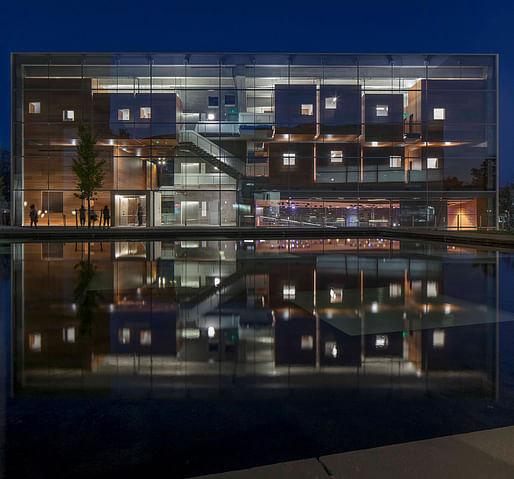 Photograph of the Lewis Center for the Arts, the music building at night as seen across the reflecting pool, Princeton, NJ, 2017. Image: Courtesy of Paul Warchol. 