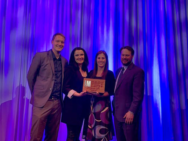 Boulder Associates’ Keith Fronczak, Tatyana Lemon, Paula Sullivan and Clinica Family Health president and CEO Simon Smith celebrate the 2019 Impact Award win.