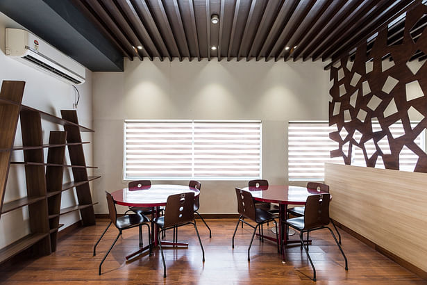 False ceiling and flooring are used to distinguish areas within the café 
