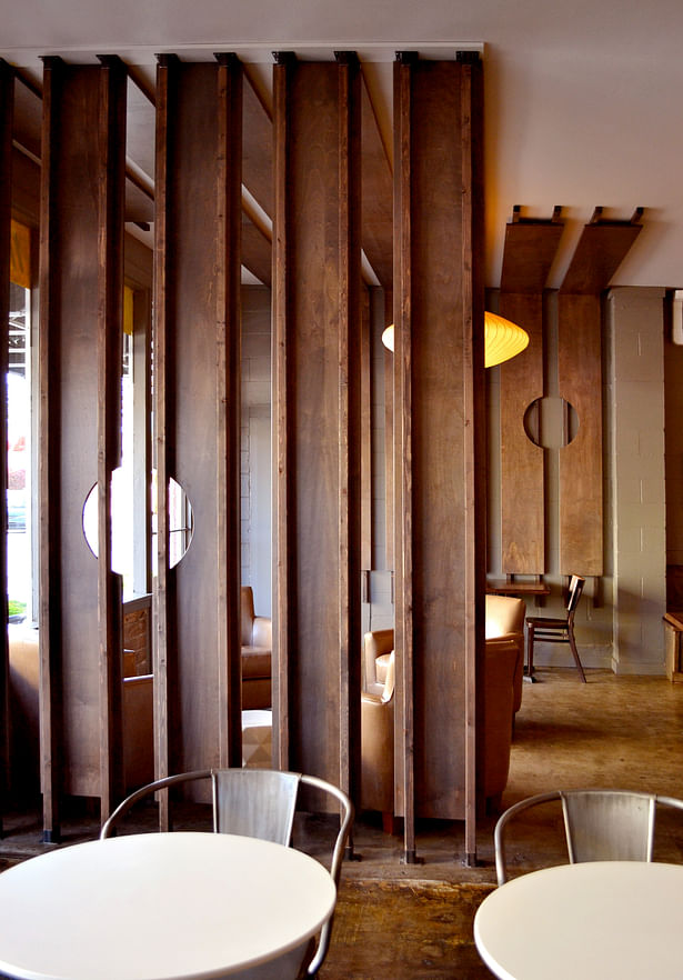 The construction of the wood paneling is visible from the entry to the cafe