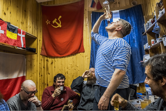 Russians and a Chilean scientist drink homemade Vodka (photo by Daniel Berehulak for the New York Times)