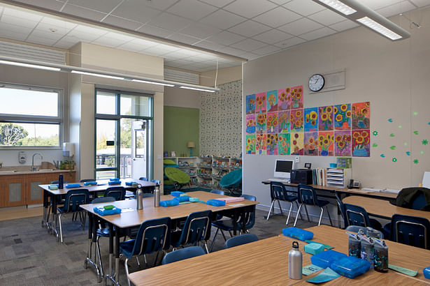 Classroom with reading nook has natural daylight, fresh air ventilation.