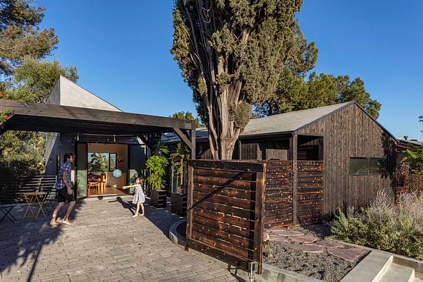 The carport was re-conceived as an exterior courtyard with robust connections to the adjacent living spaces, including the dining room beyond.