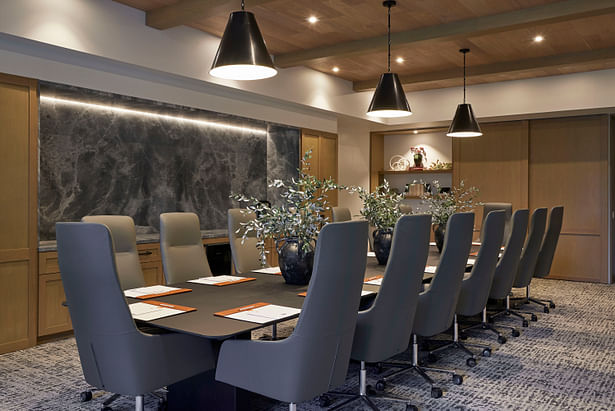 The Think Tank meeting room features warm wood tones, monumental stone wraps, and residential touches. (photo by Noah Webb)