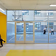 Daylight, colorful accent walls and seating nooks enhance the school interiors. Photo © Ashok Sinha