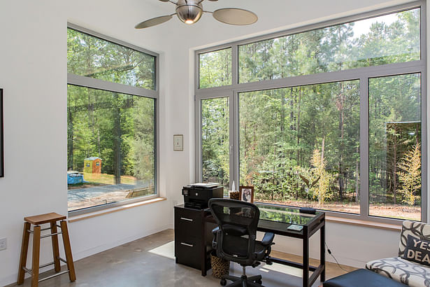 Oversized windows on two sides provide an abundance of natural light for the office/jewelry studio.