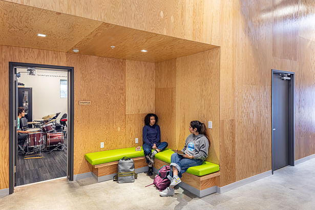 By using warm materials such as rotary cut douglas fir plywood, the negative space between the distinct programmatic volumes is transformed into engaging social space.