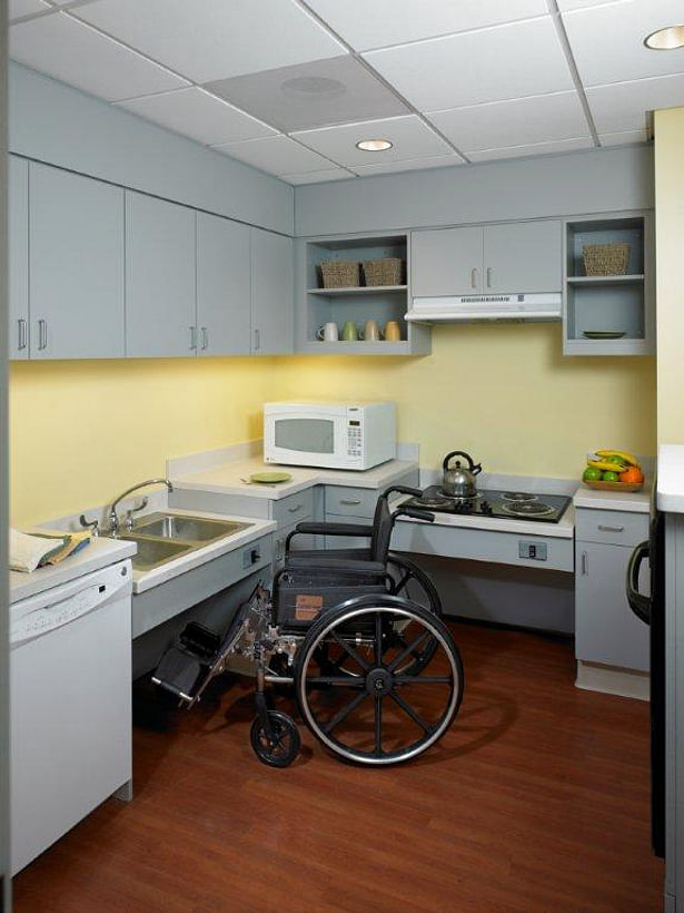 Assisted Daily Living kitchen with vertically adjustable sink and stove top. Not seen: Full size refrigerator, oven, washer and dryer