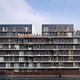 Street Facade: 'We brought forth a building with a clean and simple reading. The facades are lined with exterior balconies punctuated by steel boxes and glass openings, to lighten the impression of a mass.' (Photo: Julien Lanoo)