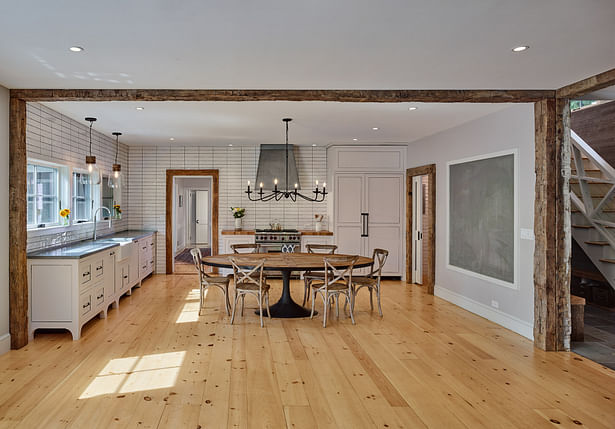 The wide-planked pine floors of the original house were extended into this addition, which found its form in a large open-plan kitchen and living room.