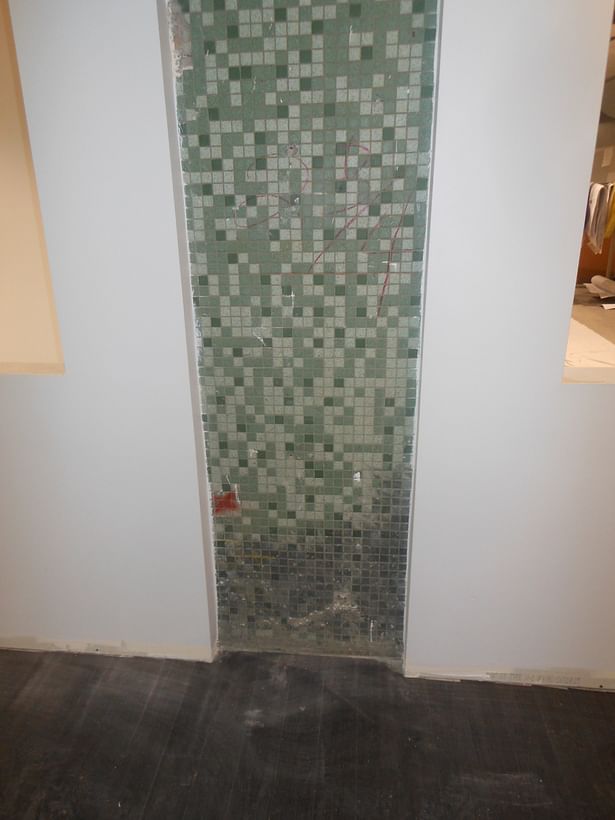 Mosaic tile from the original Sears building is exposed in the Reception Lobby