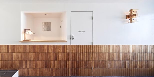 Half-tiled walls, Frank Lloyd Wright design elements, and playful execution are consistent features of the Fujio Dental Clinic.