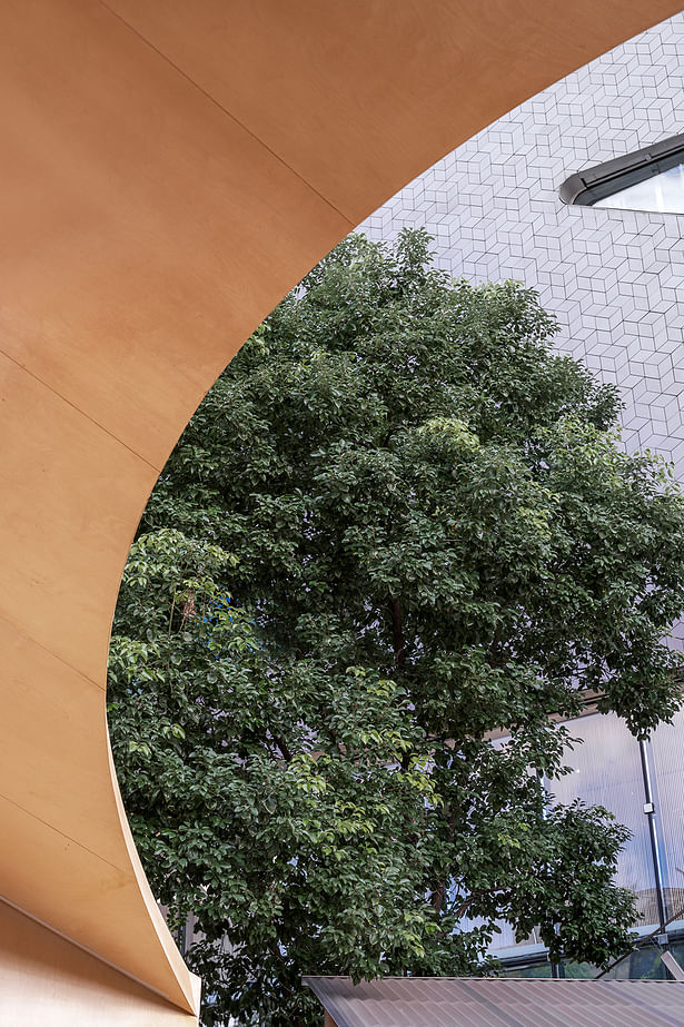 The curved roof of the engawa 'cuts' the urban landscape