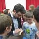 Danny Forster, who hosts Build It Bigger on the SCIENCE channel, signs autographs inside the gymnasium at Chippewa Middle School after his presentation. (Jennifer Delgado/Tribune)