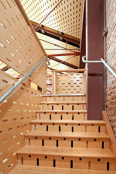 Custom slotted plywood used in mezzanine stair.