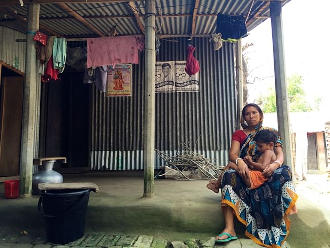 A woman and her son sit outside their dirt floored house. Dirt floors are an all too common aspect of substandard housing and harbor potentially fatal parasites and bacteria. Image courtesy of ARCHIVE.